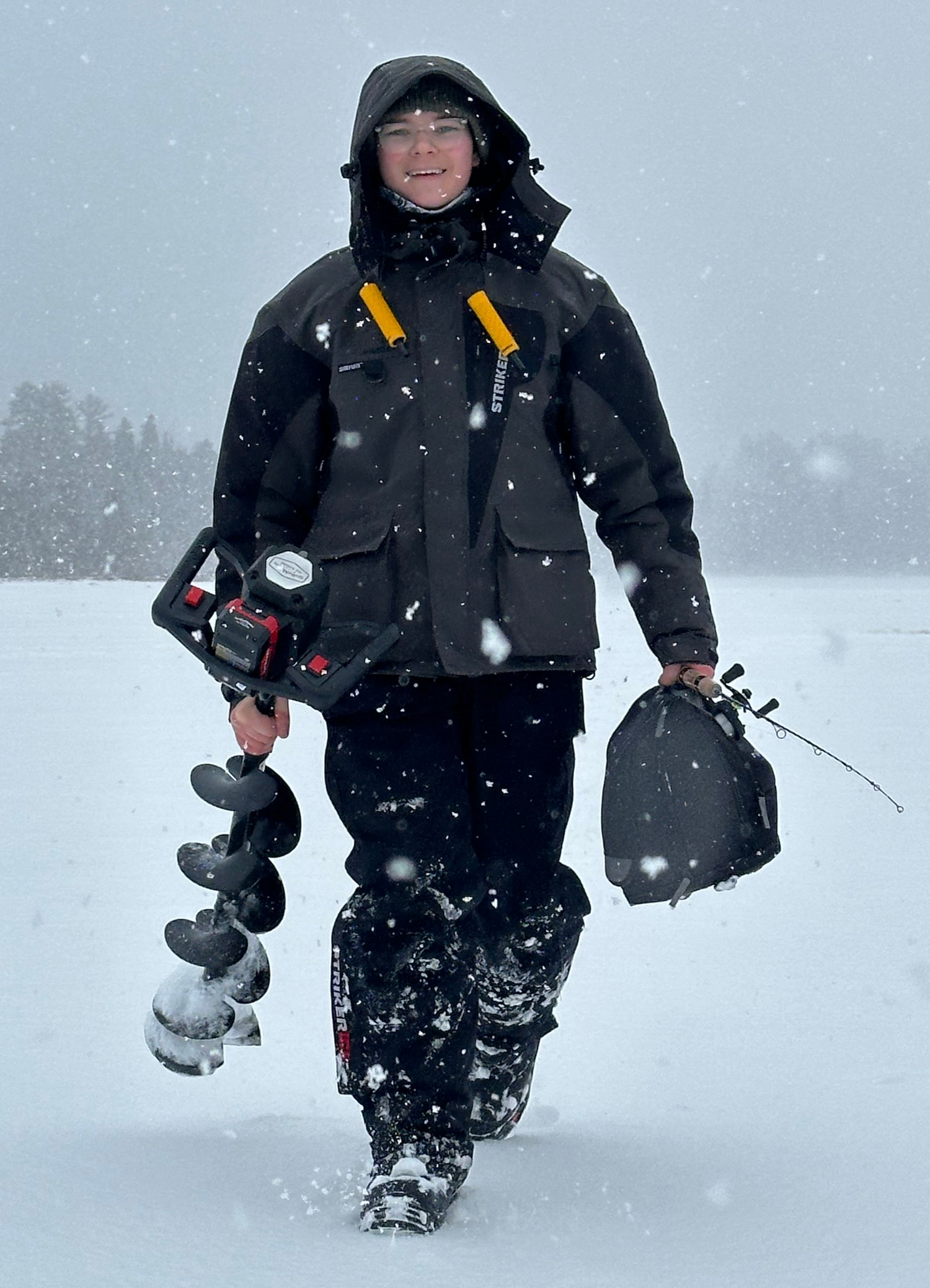 Caleb Thomas walking on lake ice fishing